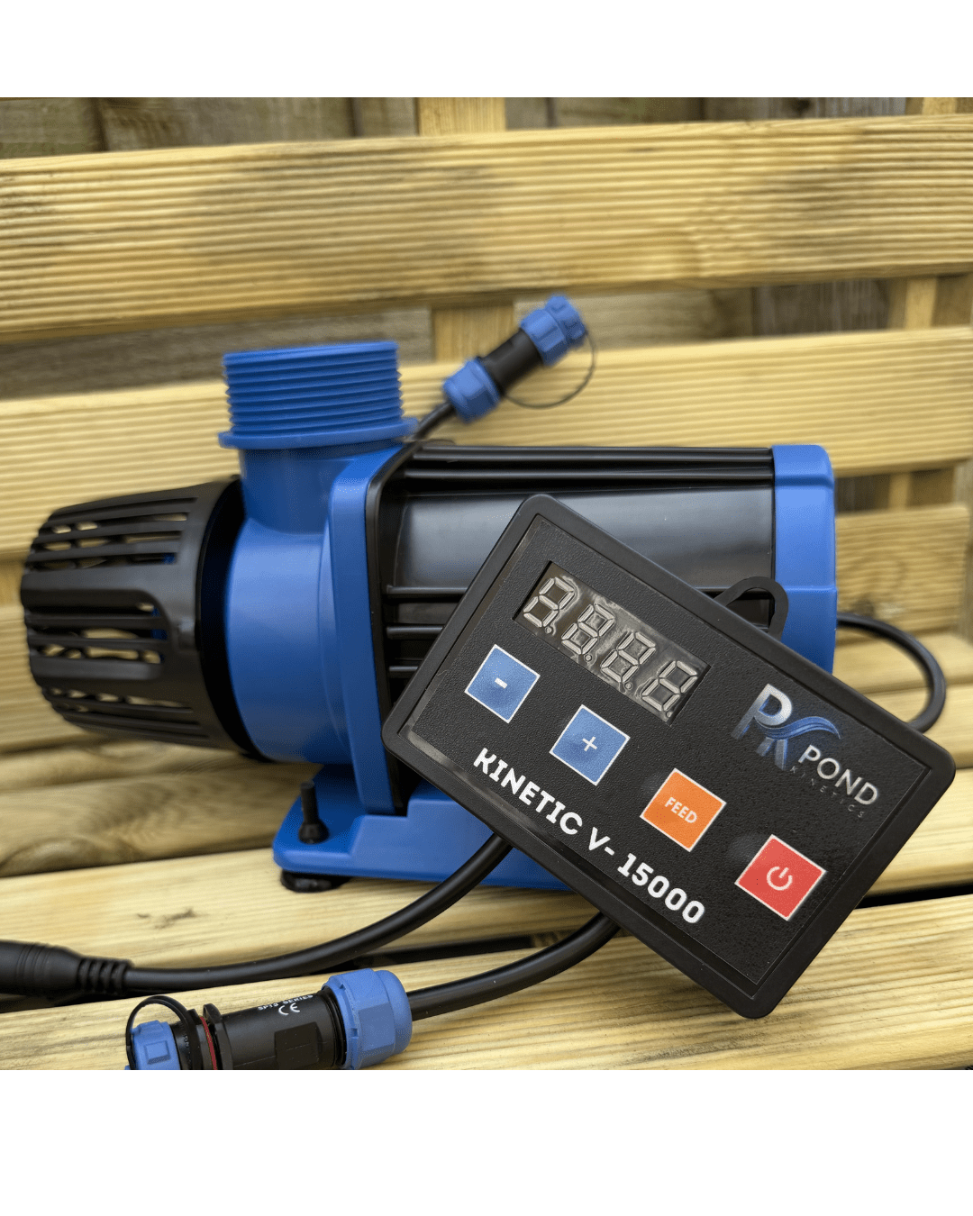 Blue and black pond pump with an attached digital control panel displaying 'PK POND KINETIC V-15000' on a wooden surface.